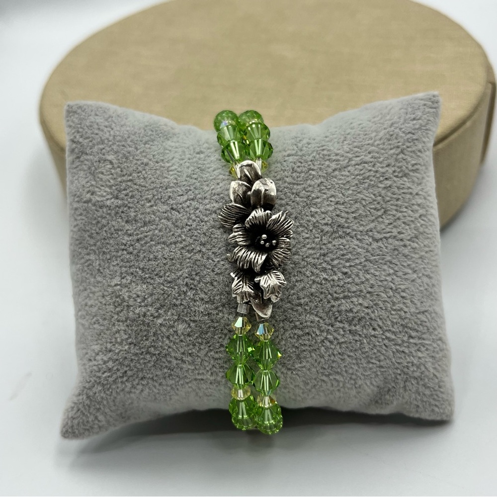 Woman’s Green and sterling Silver Beaded Charm Bracelet